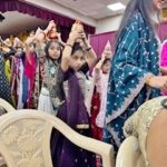 A group of young girls with ‘kalash’ on their heads, walked through the audience to the stage at the final segment of the Golden Jubilee of the Flushing Swaminayan Mandir. PHOTO: Provided by Pragna Patel