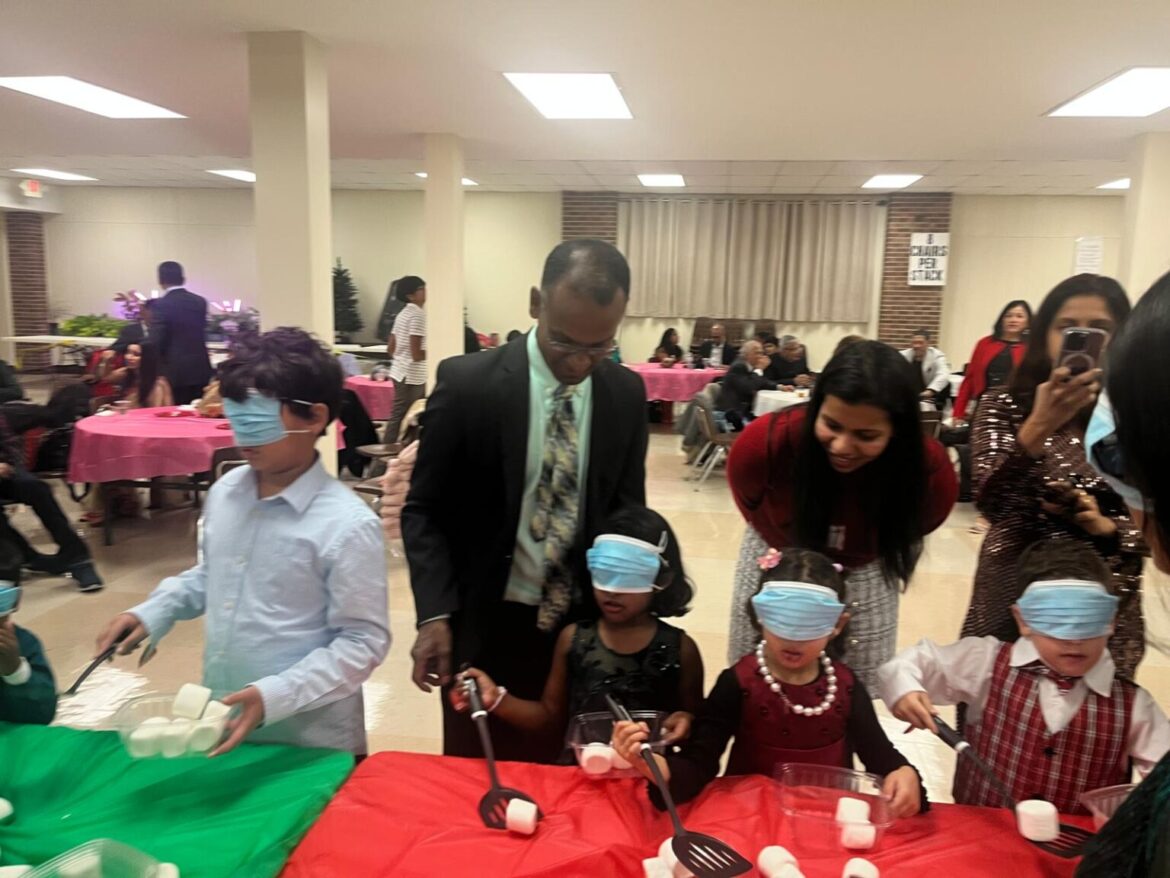 Children engaged in a game where they scooped marshmallows while blindfolded, one of several games they played at the MKCA Christmas celebration December 14, 2024, in Chicagoland. ALL PHOTOS: MKCA