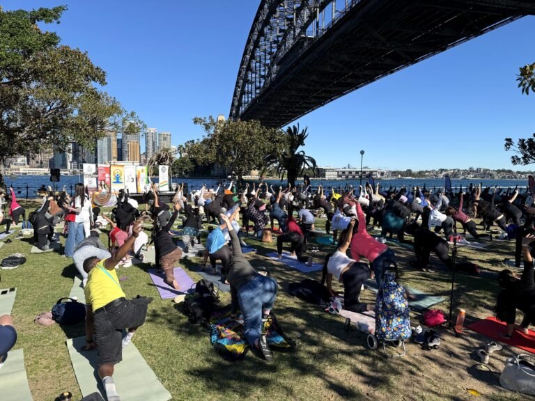 Hundreds participate in the International Day of Yoga 2026 at Bradfield Park, Sydney, with Sydney Harbor Bridge overhead, on June 21, 2026. PHOTO: SRMD
