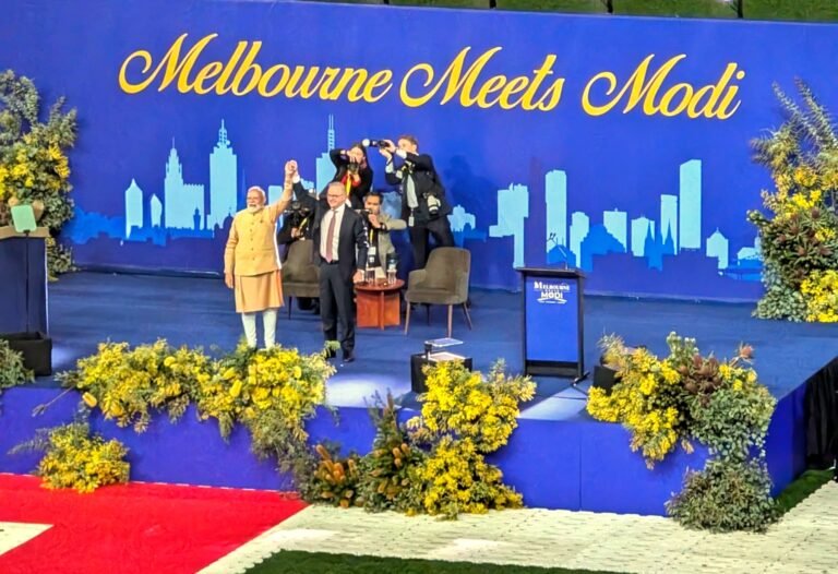 Indian Prime Minister Narendra Modi and Australian Prime Minister Anthony Albanese raise their hands together on stage at Marvel Stadium during the Melbourne Meets Modi community reception on July 9, 2026. PHOTO: Pooja Bhardwaj, SAH